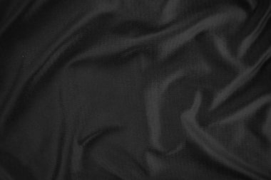 Arkaplan dokusu siyah kumaş. Soyut koyu dalgalı yumuşak. Kumaş kırışmış. Lüks moda tarzı..