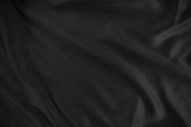 Arkaplan dokusu siyah kumaş. Soyut koyu dalgalı yumuşak. Kumaş kırışmış. Lüks moda tarzı..