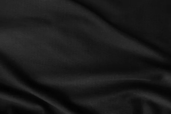 Arkaplan dokusu siyah kumaş. Soyut koyu dalgalı yumuşak. Kumaş kırışmış. Lüks moda tarzı..