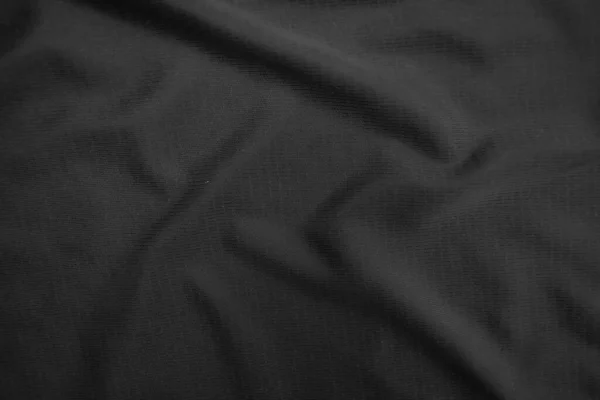 Smooth black cloth background folds. Black background abstract