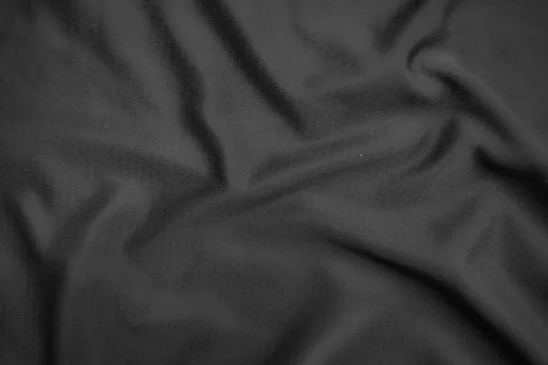 Arkaplan dokusu siyah kumaş. Soyut koyu dalgalı yumuşak. Kumaş kırışmış. Lüks moda tarzı..