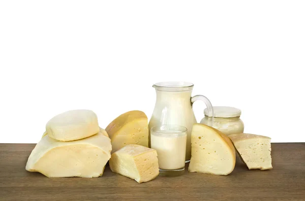 Milk, sour cream, cheese on wooden table on a white background with space for text