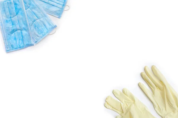Frame of medical hand gloves, blue disposable mask on white background with space for text. Protection from virus, coronavirus