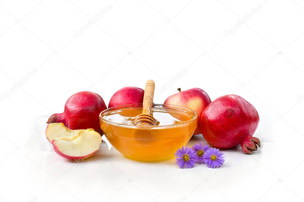 Honey in glass bowl, wooden honey dipper, red apples, garnet and flowers on a white background with space for text