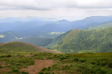 Tepeli dağların manzarası ve bulutlu gökyüzü. Karpat Dağları