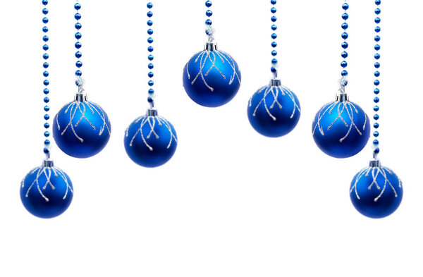 Christmas decoration. Hanging blue balls on abstract yellow golden background with space for text