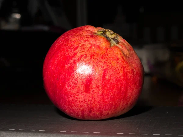Red pomegranate, Punica granatum. Black background. Close-up picture — Stock Photo, Image