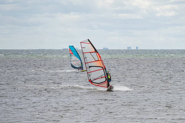 Op een winderige dag maken veel mensen van de gelegenheid gebruik om watersporten te beoefenen. Windsurfers verzamelen zich bij het strand van Lomma om hun windsurfvaardigheden te oefenen — Stockfoto