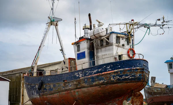 An old fishing and tour boat in a dry dock for maintenance and repair in Hundested, Zealand, Denmark — Stock Photo, Image