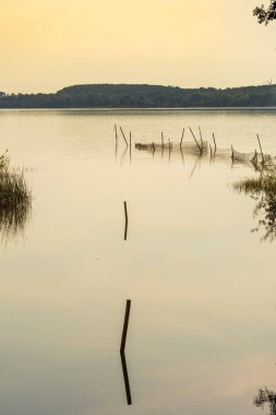 Yazın son günlerinden birinde göldeki balık ağlarının güzel günbatımı manzarası. Fotoğraf: Ringsjon, Scania, Güney İsveç