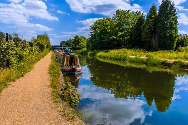 Narrow boats moored on the Birmingham Canal at Tipton in summertime clipart