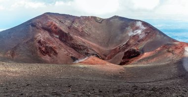 Sicilya 'nın Etna Dağı' nın zirvesinde demir yatakları olan dumanı tüten bir krater.