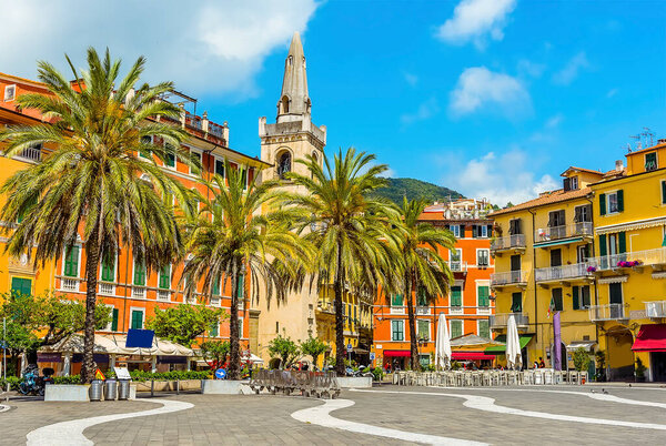 The church and colourful buildings stand proud in the central square in Lerici, Italy in the summertime