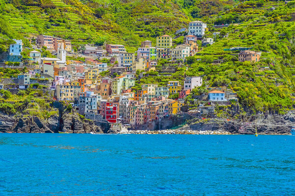 A close-up view of the Cinque Terre, fishing village of Riomaggiore, Italy and surrounding cliffs in summertime