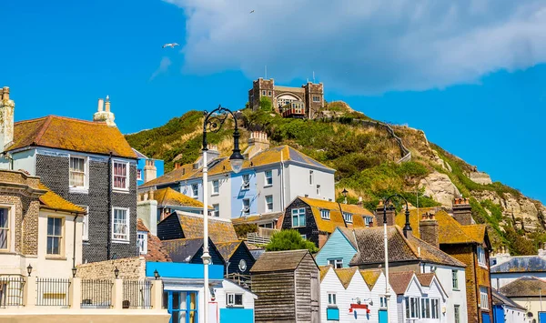 The unique and individual buildings of Hastings old town dominated by the east cliff and funicular railway in summer