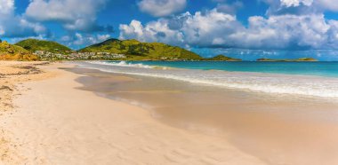 A view along Orient beach in St Martin towards the headland clipart