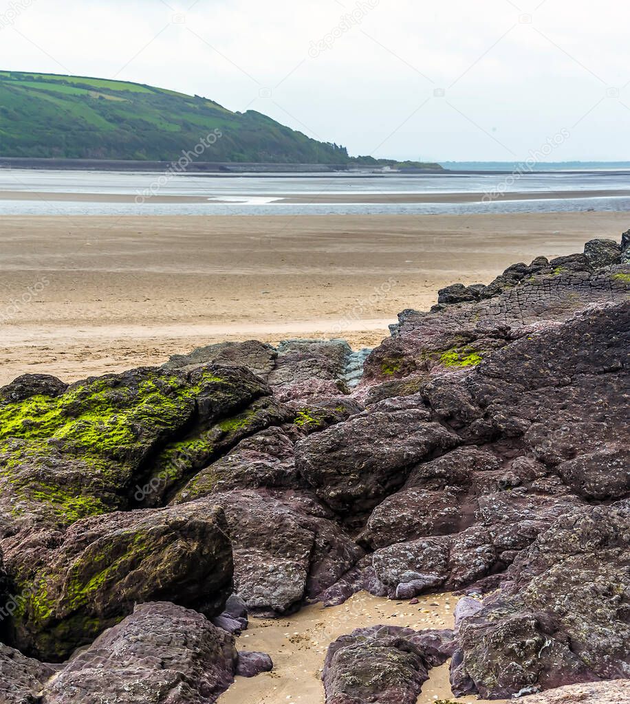 A view across the beach at Llansteffan, Wales across the river Towy estuary in the summertime