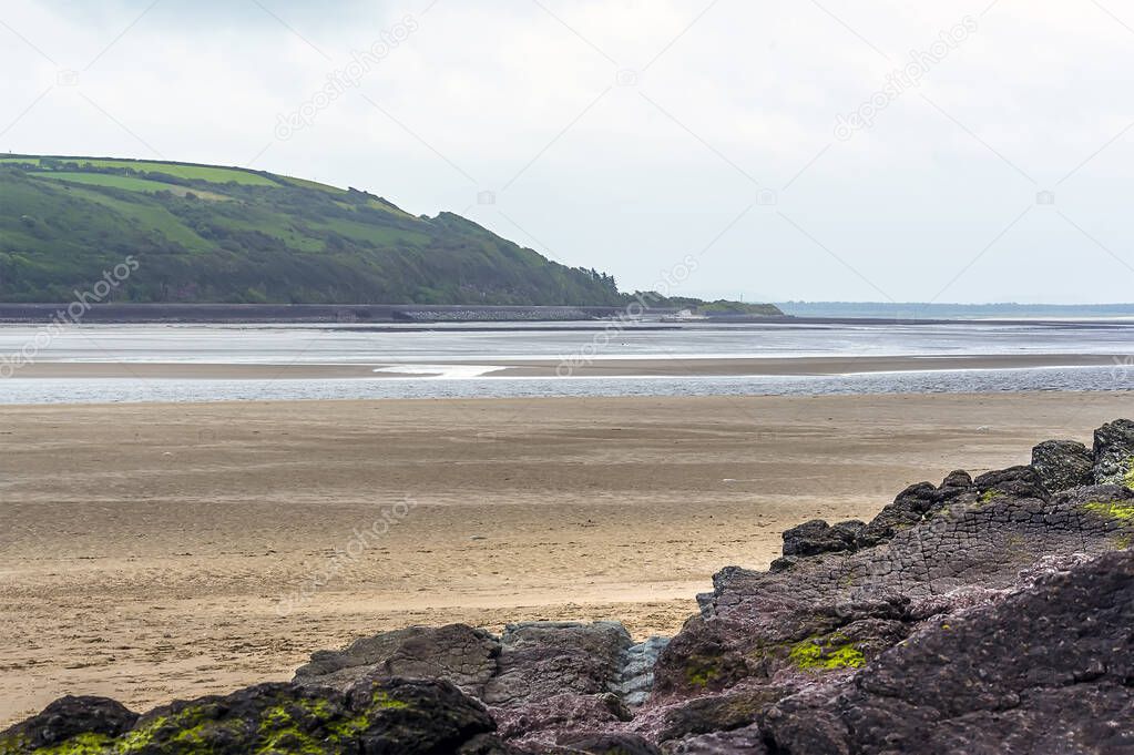 A view across the beach and river Towy estuary at Llansteffan, Wales in the summertime