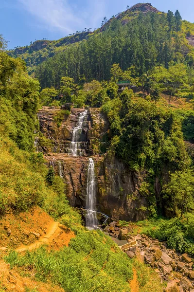 Water cascades over two vertical cliff faces at Ramboda Falls in upland tea country in Sri Lanka, Asia