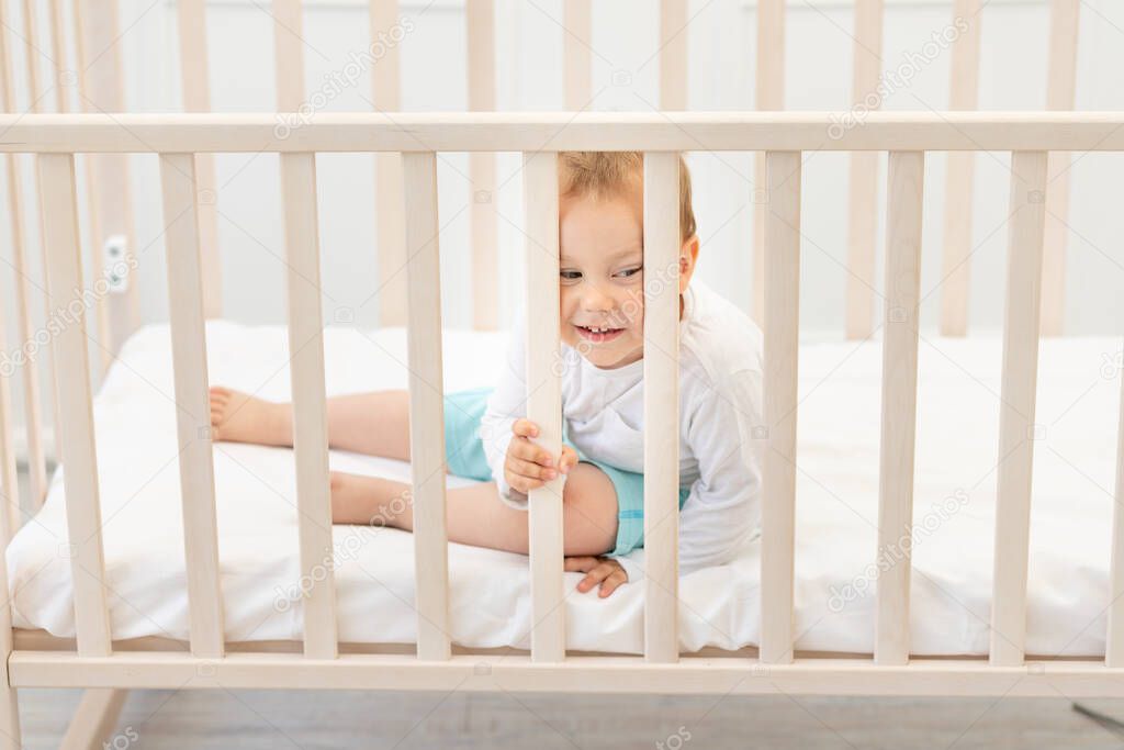 baby in the crib waiting for mom, baby 2 years in the crib.