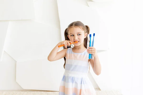 Menina Escovar Dentes Fundo Branco Segurando Escovas Dentes Lugar Para — Fotografia de Stock