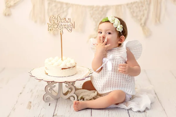 happy girl one year tries cake, birthday 1 year