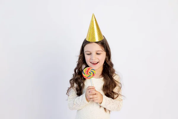 Cute Little Girl Eating Large Lollipop Festive Hat White Isolated — Stock Photo, Image