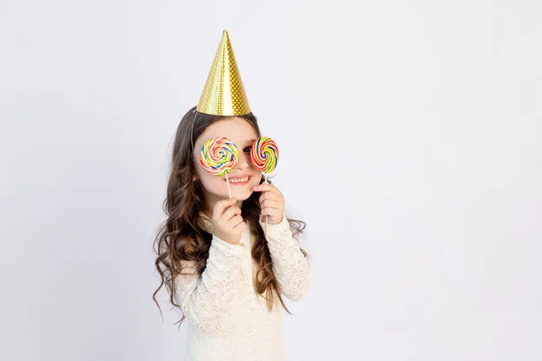 Cute Little Girl Two Big Lollipops Her Eyes Festive Hat — Stock Photo, Image