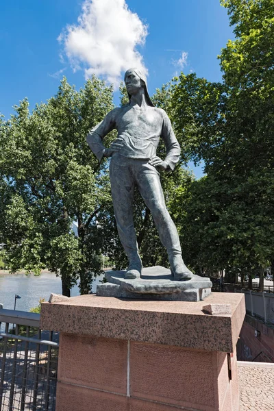 Sculpture The harbor worker (the dock worker, build by artist Constantin Meunier in 1899) on the Friedensbrucke in Frankfurt, Germany