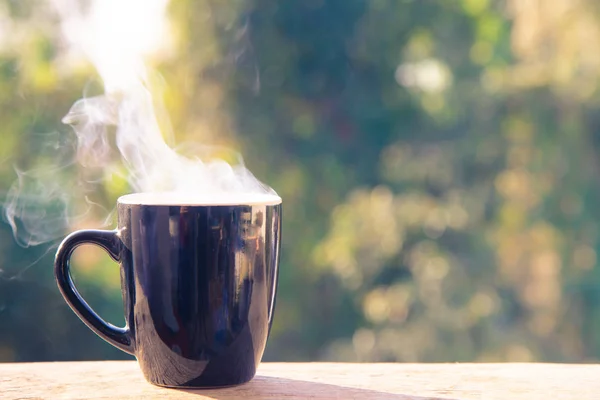 coffee cup with white smoke on blur background.