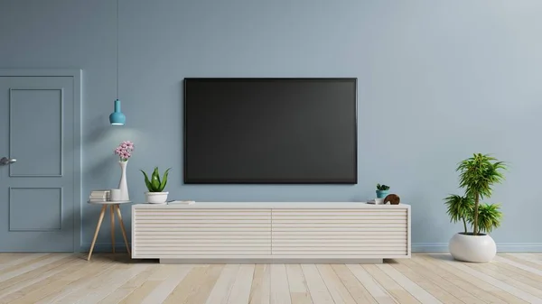 蓝墙背景的现代客厅橱柜里的电视 3D渲染 — 图库照片