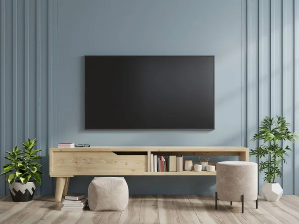 现代客厅橱柜上的电视机 背景是深蓝色的墙 3D渲染 — 图库照片