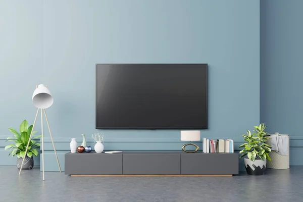 现代客厅橱柜上的电视机 背景是深蓝色的墙 3D渲染 — 图库照片