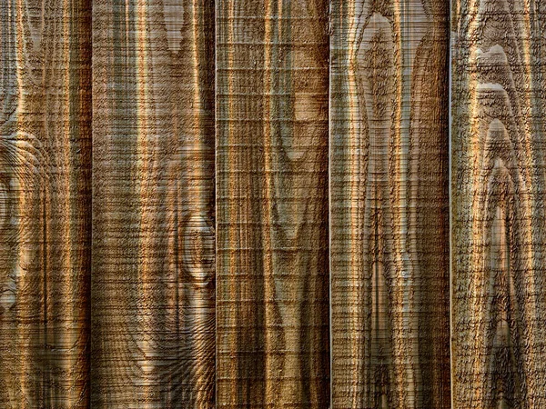 A close up section of vertical overlapping wooden fencing panels with knots in brown