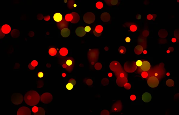 一种稀疏分散的灯火通明的节日灯饰图案 黑色上有红色和黄色阴影 用作背景 — 图库照片