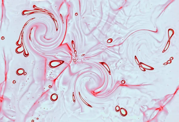 A fluid liquid macro with swirling red droplets in 3D illustration