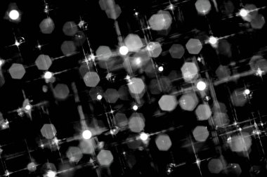 Siyah ve beyaz tonlarında, yıldız etkisine sahip yüzen, altıgen bir bokeh tasarımı
