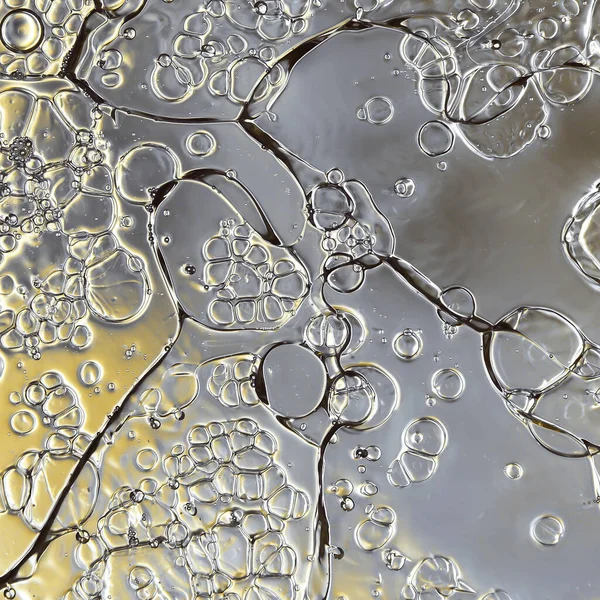 油と水のマクロの抽象的な背景と氷の効果と金の色合い — ストック写真