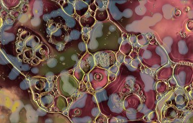 Pembe yeşil ve gri arkaplandaki yağ ve su soyutu.