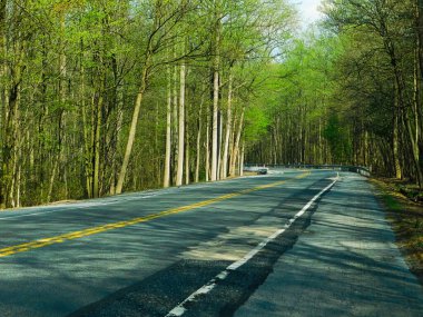 A highway (Rt 322) cutting through state game lands in northern Lancaster county, in the springtime