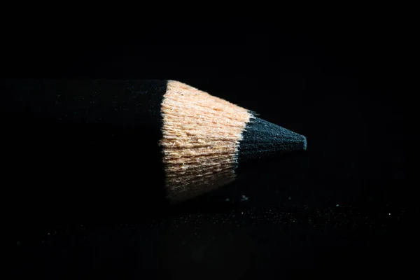 A macro shot of a black pencil tip. Kept in a dark background