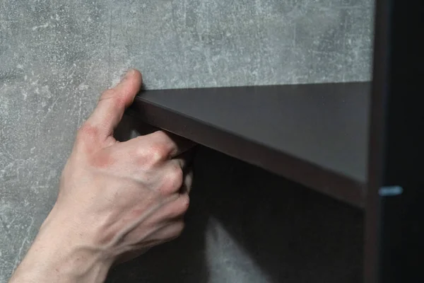 professional assembling furniture with a special tool, close up, blurry background