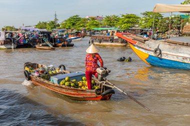 Can Tho / Vietnam - March 05 2019: A vendor at the Cai Rang floating market. clipart