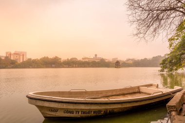 Hanoi / Vietnam - 16 Mart 2019: Hoan Kiem Gölü 'ndeki Kaplumbağa Kulesi (Thap Rua) Sabah Işığı önünde bir tekne ile.