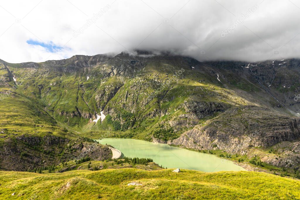 The emerald green Margaritze stausee lake on the Grossglockner High Alpine Road, Austria.