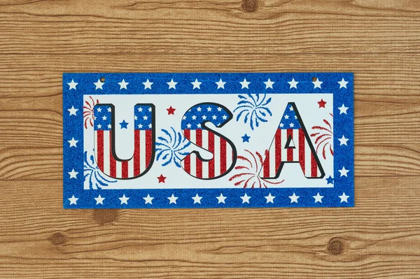 Celebrating Independence Day July 4th, President's Day, Memorial Day, Labor Day, Veteran's Day, Great America. USA sign in the colors of the flag of the United States on a wooden background.