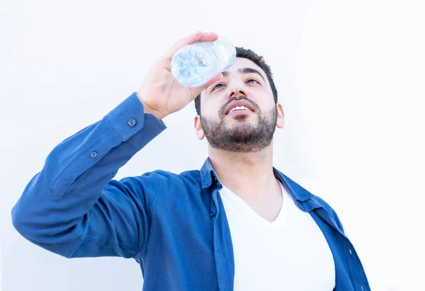 Arabic guy drinking water from bottle