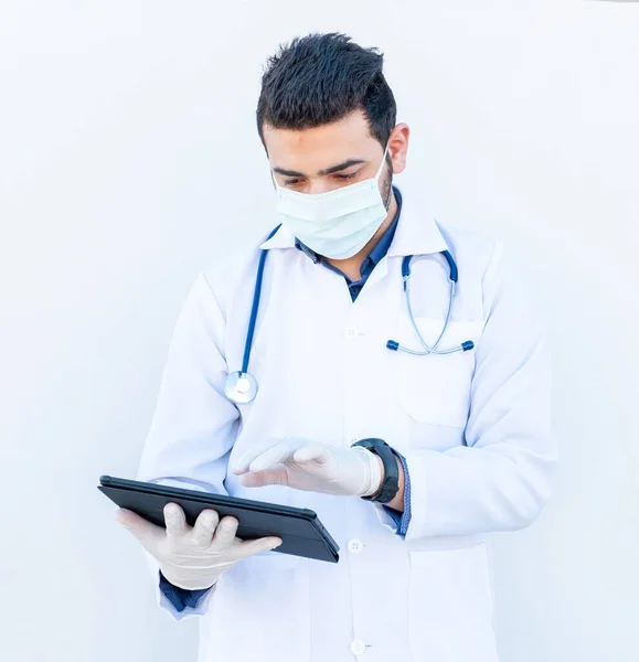 Arabic doctor using his smart phone to discuss medical stuff online