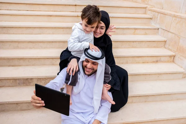 Happy arabic muslim family using video to call their family