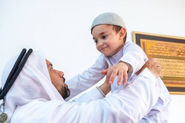 Arap Müslüman baba oğlunu yüksekte tutuyor.